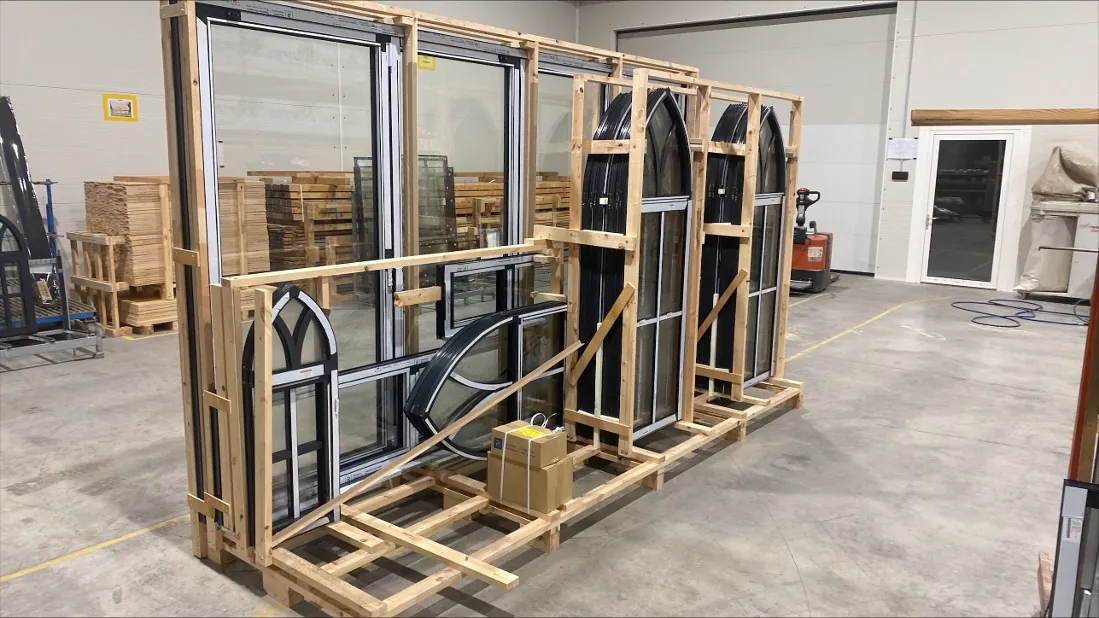 Arched and rectangular window frames crated in a workshop before delivery